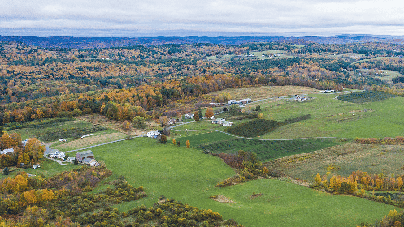 An aerial view of a farm in the fall, perfect for buying ag land.