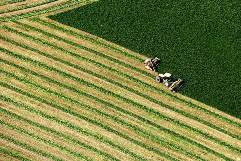 An aerial view of a regenerative agriculture tractor plowing a field.