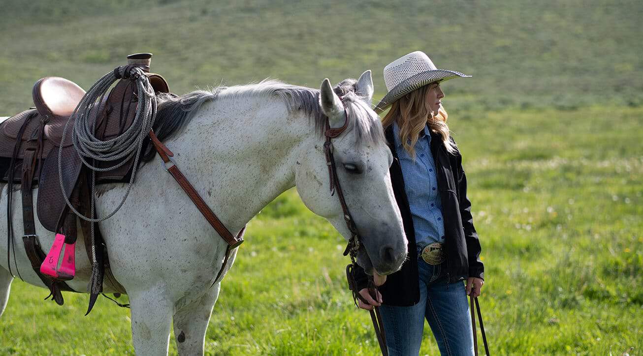 A female rancher with her horse.