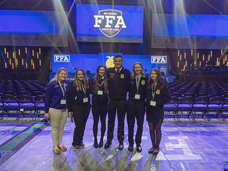 Cassie Perrin standing with students at the National FFA Convention.