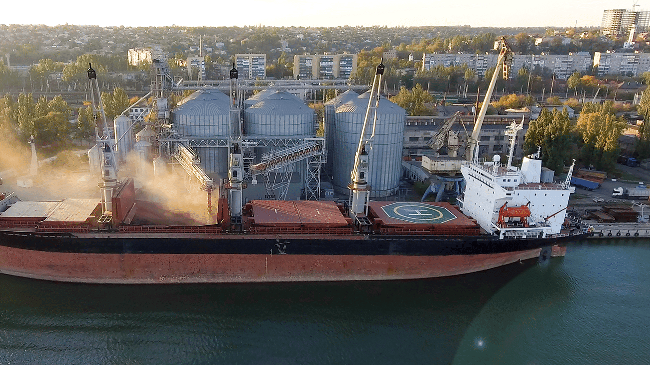 An aerial view of a large ship engaged in agriculture trade on the water.