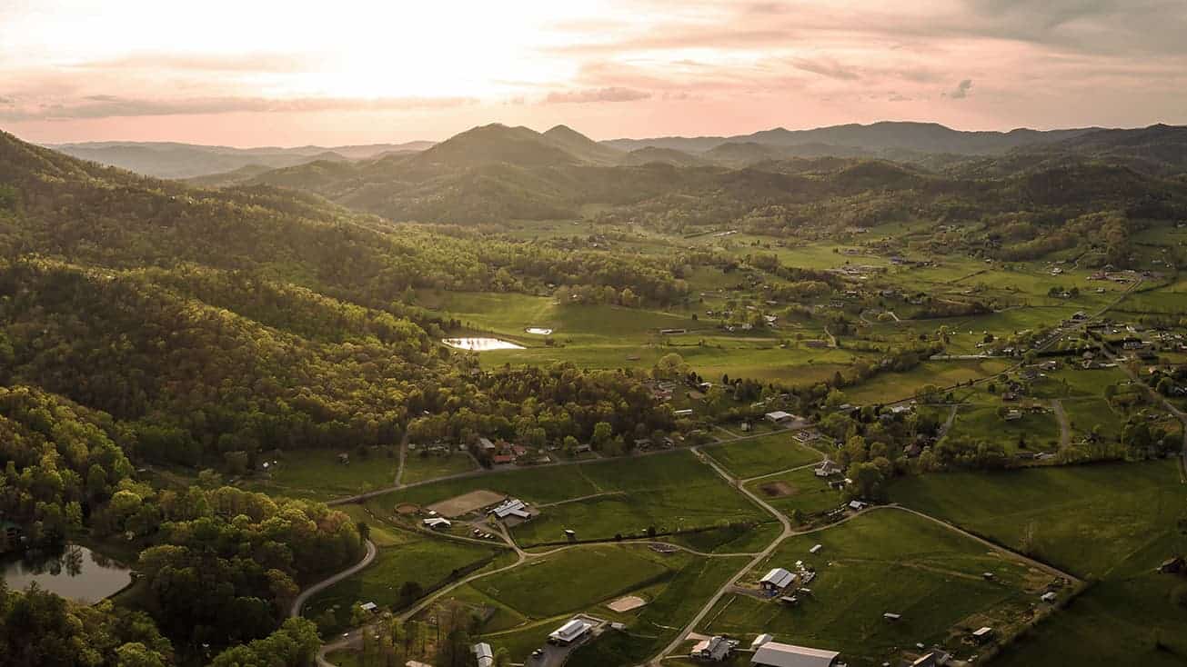 An aerial view of a village nestled in the mountains.