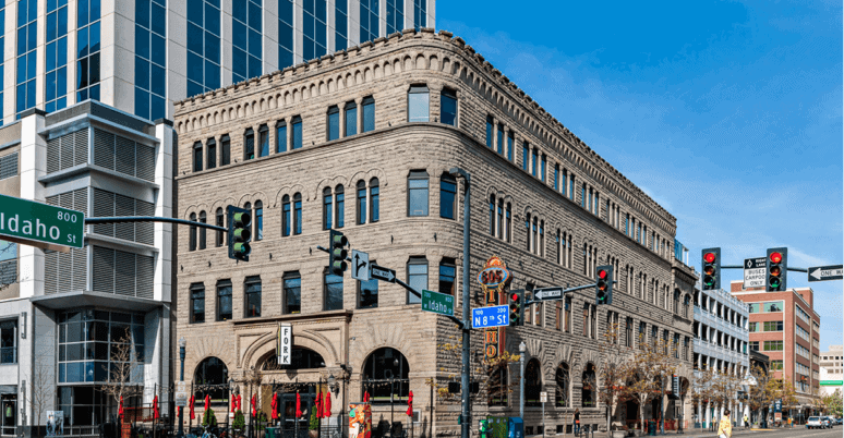 An old building on a street corner that is search engine optimized and equipped with relevant keywords for easy contact.